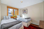 This cozy bedroom features two twin beds, perfect for guests or a shared living space.