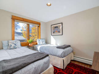 This cozy bedroom features two twin beds, perfect for guests or a shared living space.