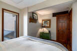 This cozy bedroom features a comfortable bed with a stylish blanket, perfect for a relaxing retreat.