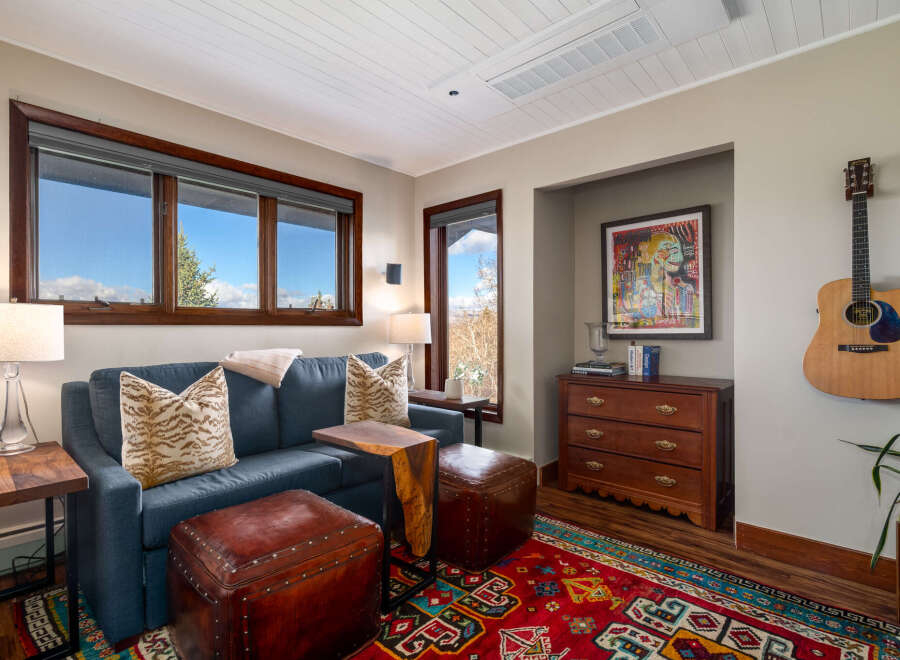 Step into this inviting living space, featuring a cozy blue sofa adorned with stylish throw pillows.