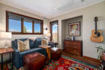 Step into this inviting living space, featuring a cozy blue sofa adorned with stylish throw pillows.