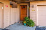 Charming property entrance with a warm, inviting wooden door and a welcoming porch.
