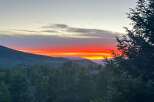 Enjoy breathtaking sunsets from this stunning property! This home offers panoramic views of the mountains and lush greenery.