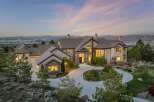 This stunning estate boasts a grand facade with a circular driveway, offering an impressive curb appeal.