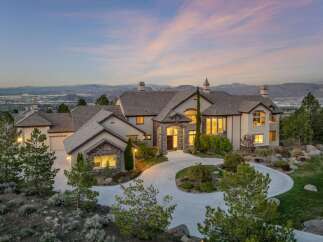 This stunning estate boasts a grand facade with a circular driveway, offering an impressive curb appeal.