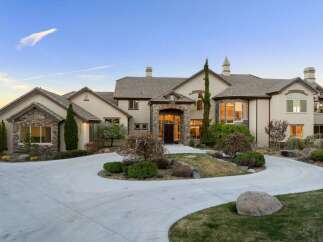 This stunning property boasts a grand entrance with a circular driveway, perfect for welcoming guests.