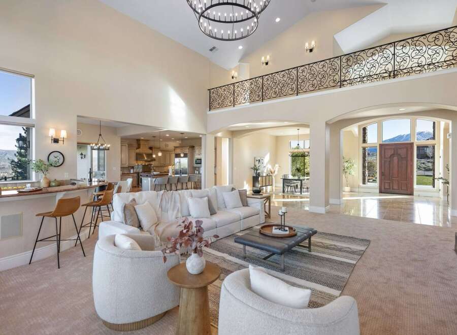 Step into luxury with this stunning property, showcasing a grand entryway and an open-concept living space.
