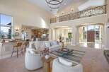 Step into luxury with this stunning property, showcasing a grand entryway and an open-concept living space.