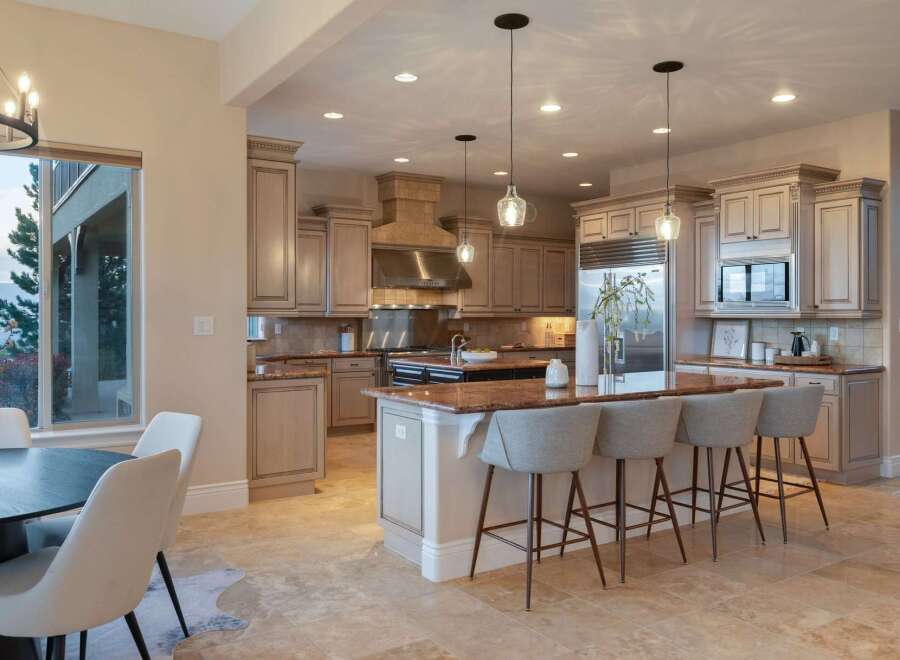 This stunning kitchen boasts elegant cabinetry, a spacious island with seating, and top-of-the-line appliances.