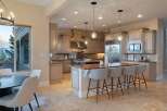 This stunning kitchen boasts elegant cabinetry, a spacious island with seating, and top-of-the-line appliances.