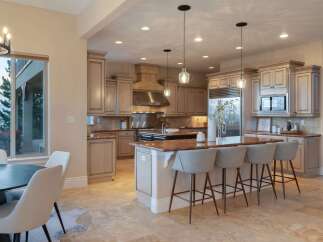 This stunning kitchen boasts elegant cabinetry, a spacious island with seating, and top-of-the-line appliances.