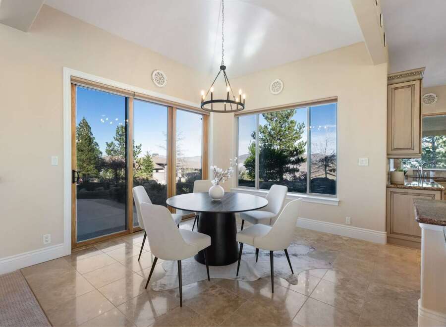 Experience luxury living in this stunning dining area! Featuring a modern round table, stylish chairs, and a unique cowhide rug, this space is perfect for entertaining.