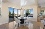 Experience luxury living in this stunning dining area! Featuring a modern round table, stylish chairs, and a unique cowhide rug, this space is perfect for entertaining.