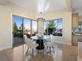 Experience luxury living in this stunning dining area! Featuring a modern round table, stylish chairs, and a unique cowhide rug, this space is perfect for entertaining.