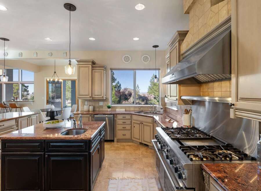 Step into luxury with this stunning kitchen! Featuring granite countertops, stainless steel appliances, and custom cabinetry, this space is perfect for both cooking and entertaining.