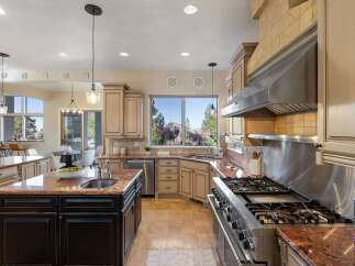 Step into luxury with this stunning kitchen! Featuring granite countertops, stainless steel appliances, and custom cabinetry, this space is perfect for both cooking and entertaining.