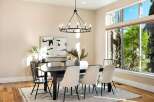 Step into luxury with this stunning dining room, featuring a modern chandelier and a stylish dining table.
