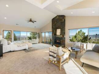 Experience luxury living in this stunning property, featuring a spacious bedroom with breathtaking views.