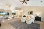Experience luxury living in this stunning property, featuring a spacious master suite with a cozy seating area.