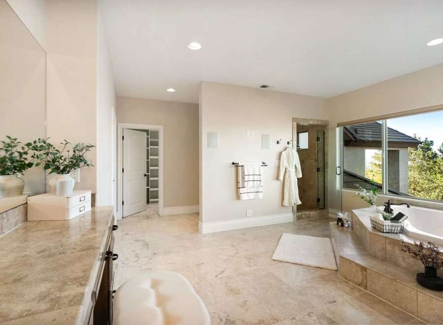 Indulge in luxury within this stunning bathroom, featuring a spacious layout and elegant design.