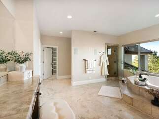Indulge in luxury within this stunning bathroom, featuring a spacious layout and elegant design.