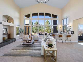 Experience luxury living in this stunning property, featuring an open-concept design with soaring ceilings and expansive windows that flood the space with natural light.