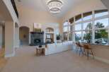 Experience luxury living in this stunning property featuring a grand living room with soaring ceilings and a cozy fireplace.