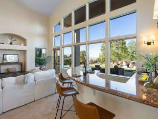 Experience luxury living in this stunning property! This home boasts a spacious interior with high ceilings and large windows that flood the space with natural light.