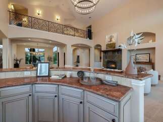 Experience luxury living in this stunning property, featuring a gourmet kitchen with granite countertops and custom cabinetry.