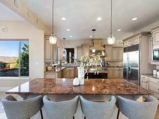 Step into luxury with this stunning kitchen, featuring a spacious island with seating, perfect for entertaining.