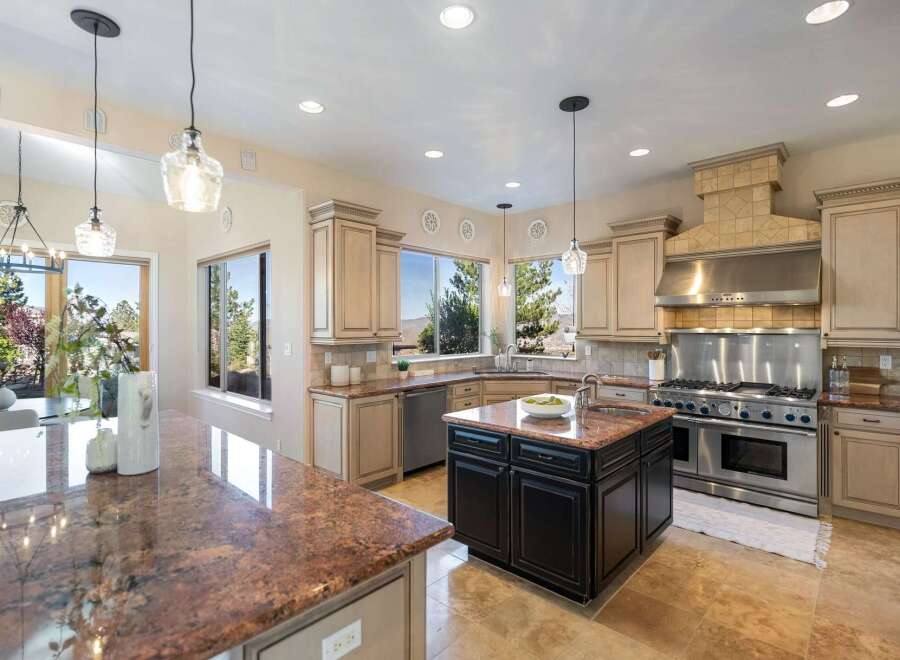This stunning kitchen boasts a spacious layout with granite countertops and ample cabinet space, perfect for culinary enthusiasts.