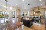 This stunning kitchen boasts a spacious layout with granite countertops and ample cabinet space, perfect for culinary enthusiasts.
