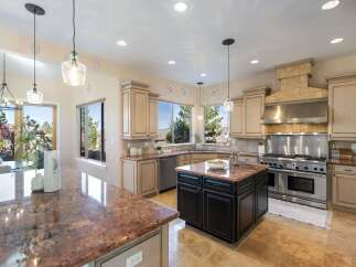 This stunning kitchen boasts a spacious layout with granite countertops and ample cabinet space, perfect for culinary enthusiasts.
