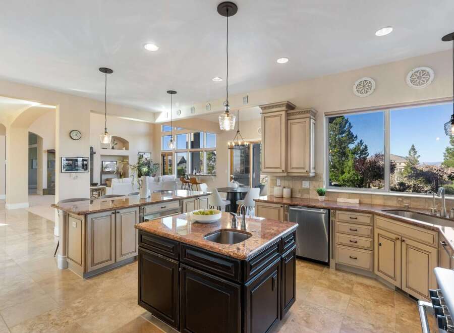 Experience luxury living in this stunning kitchen! Featuring a spacious island, granite countertops, and stainless steel appliances, this kitchen is perfect for both cooking and entertaining.