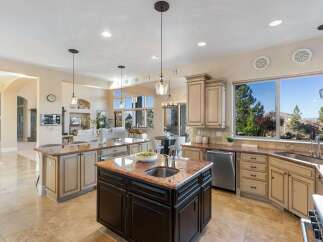 Experience luxury living in this stunning kitchen! Featuring a spacious island, granite countertops, and stainless steel appliances, this kitchen is perfect for both cooking and entertaining.