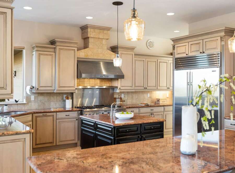 Step into luxury with this stunning kitchen! Featuring custom cabinetry, a stainless steel range hood, and granite countertops, this space is perfect for both cooking and entertaining.