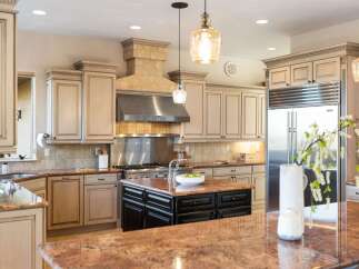 Step into luxury with this stunning kitchen! Featuring custom cabinetry, a stainless steel range hood, and granite countertops, this space is perfect for both cooking and entertaining.