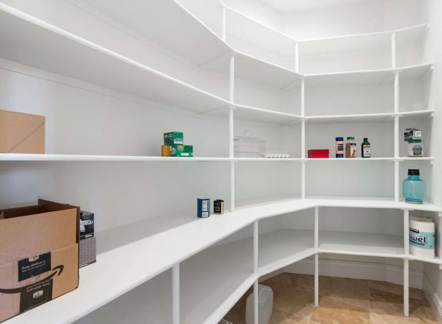 Discover the epitome of organization with this stunning pantry.