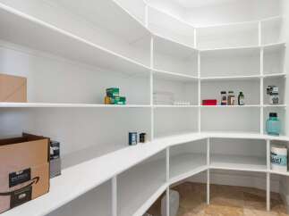 Discover the epitome of organization with this stunning pantry.