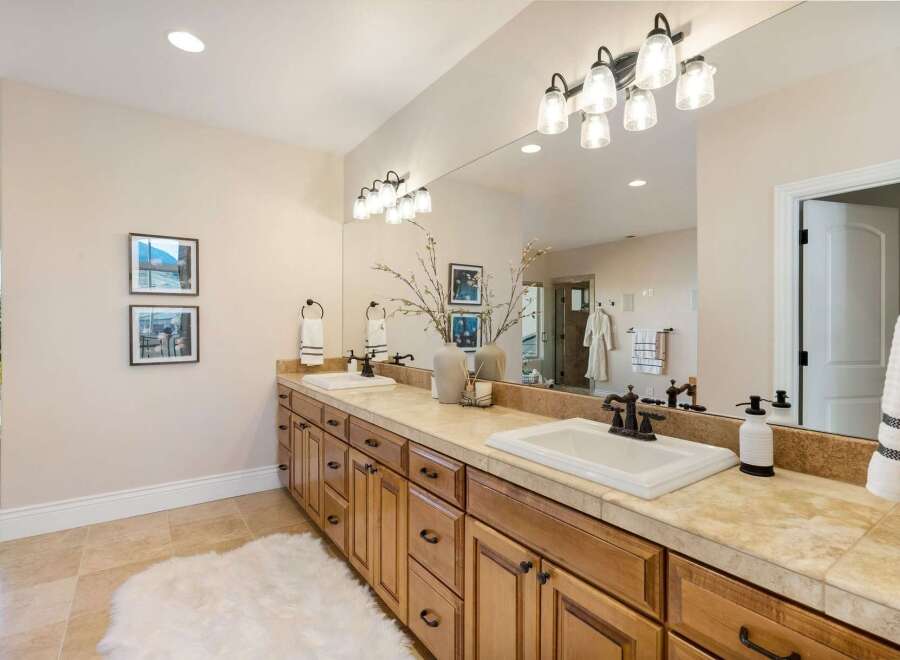 This luxurious bathroom features a double vanity with ample storage and a stunning countertop.