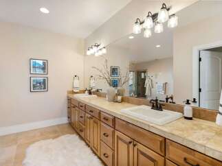 This luxurious bathroom features a double vanity with ample storage and a stunning countertop.