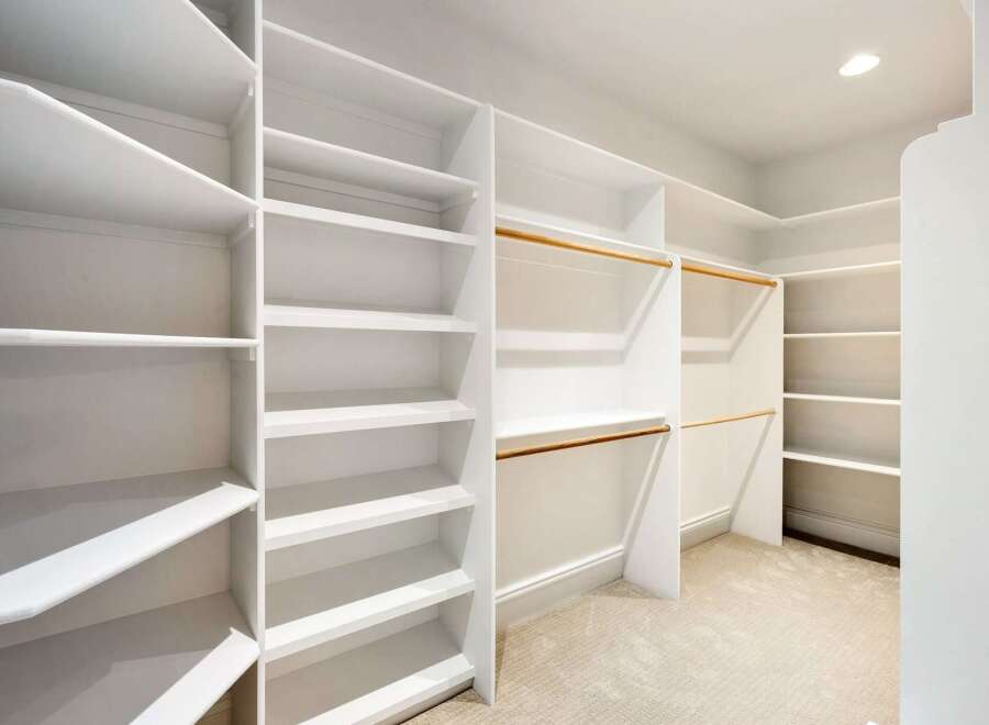 Step into luxury with this stunning walk-in closet, designed for optimal organization and style.
