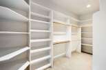 Step into luxury with this stunning walk-in closet, designed for optimal organization and style.