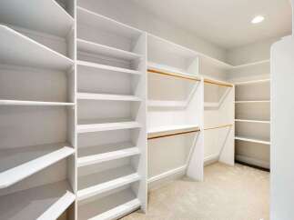 Step into luxury with this stunning walk-in closet, designed for optimal organization and style.