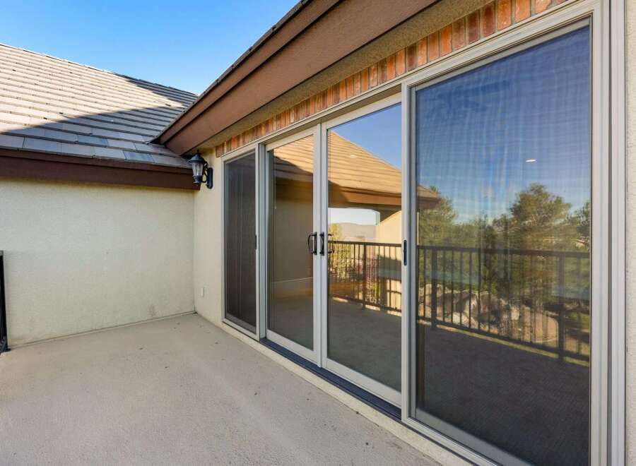 Enjoy the beautiful views from this stunning property! This home features a spacious patio with large sliding glass doors, perfect for indoor-outdoor living.