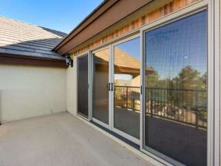 Enjoy the beautiful views from this stunning property! This home features a spacious patio with large sliding glass doors, perfect for indoor-outdoor living.