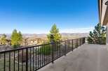 Enjoy breathtaking views from this stunning property! This home features a spacious balcony with a sleek black railing, perfect for relaxing and taking in the scenery.
