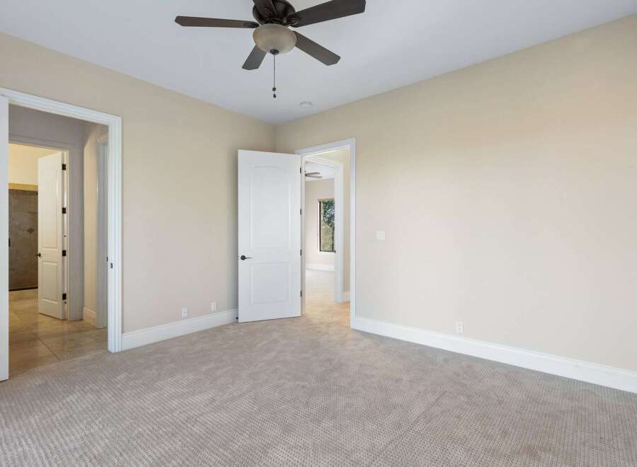 Step into this inviting bedroom, featuring neutral tones and ample natural light.