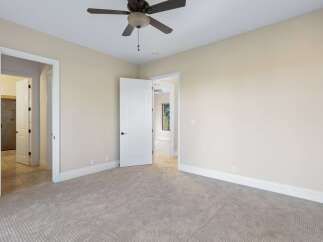 Step into this inviting bedroom, featuring neutral tones and ample natural light.