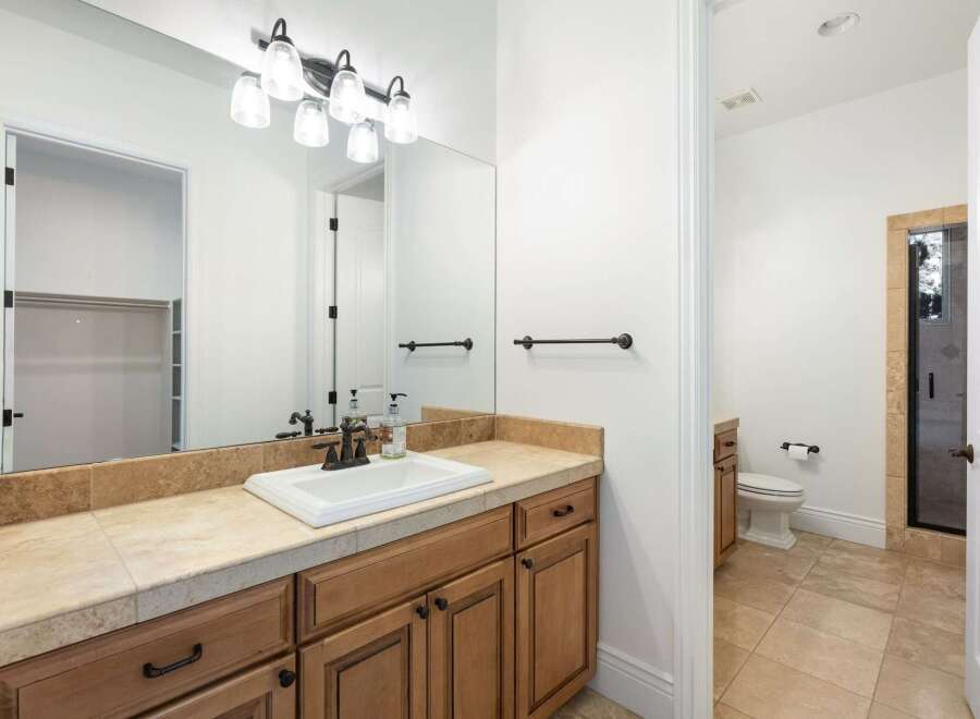 Step into luxury with this beautifully designed bathroom! Featuring a sleek vanity, ample storage, and elegant fixtures, this space is perfect for relaxation and rejuvenation.